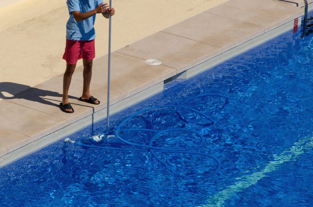 bigstock-guy-cleaning-the-swimming-pool-191620768-1024x678