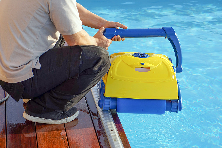 bigstock-a-pool-cleaner-holds-a-robot-c-360608176