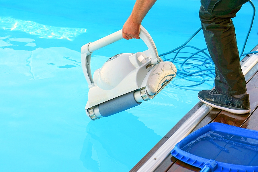 bigstock-a-pool-cleaner-holds-a-robot-c-361145923