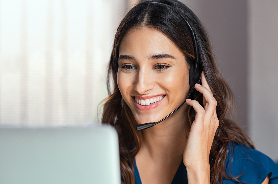 bigstock-smiling-woman-using-laptop-whi-299113399