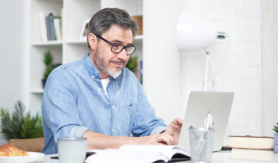 bigstock-older-man-working-online-with-409262260