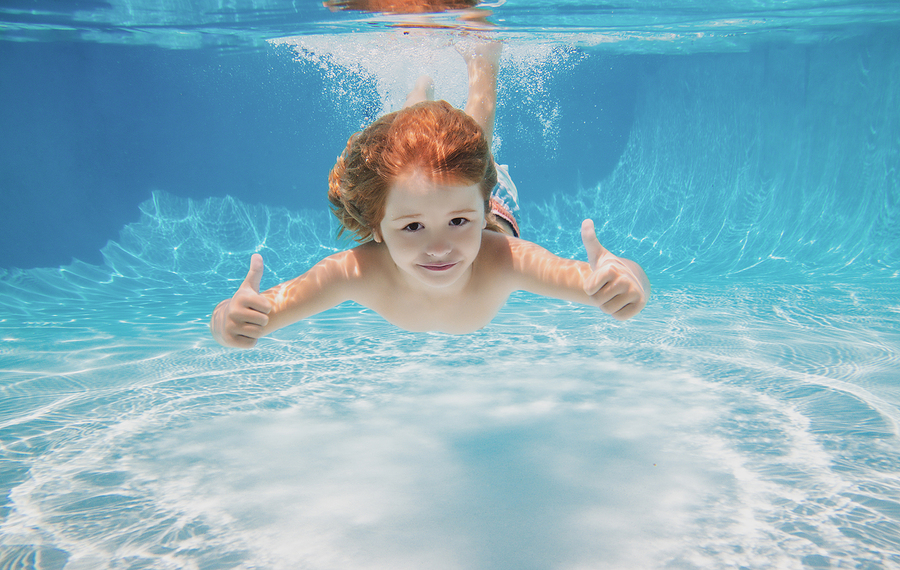 bigstock-child-swimming-underwater-with-450734175-1
