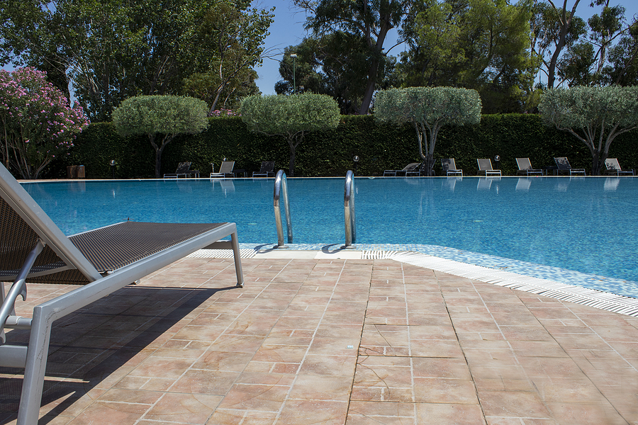 bigstock-tropical-swimming-pool-sunbed-459911845