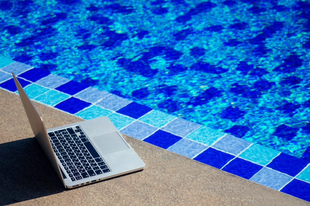 laptop-at-the-pool-remote-work-on-holiday-freelan-2024-10-30-20-55-09-utc-scaled-1024x682